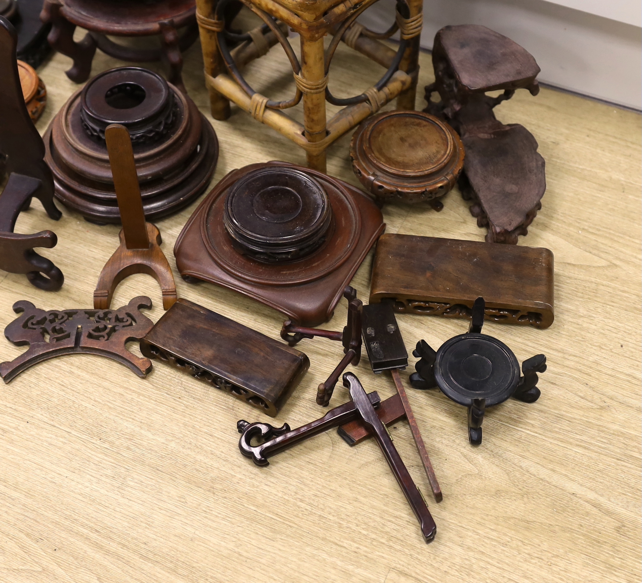 A collection of Chinese carved wooden stands and a small bamboo stand